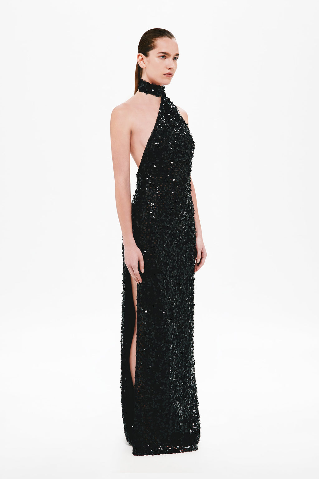 Black sequin halter maxi dress with side slit and sleeveless halter neckline