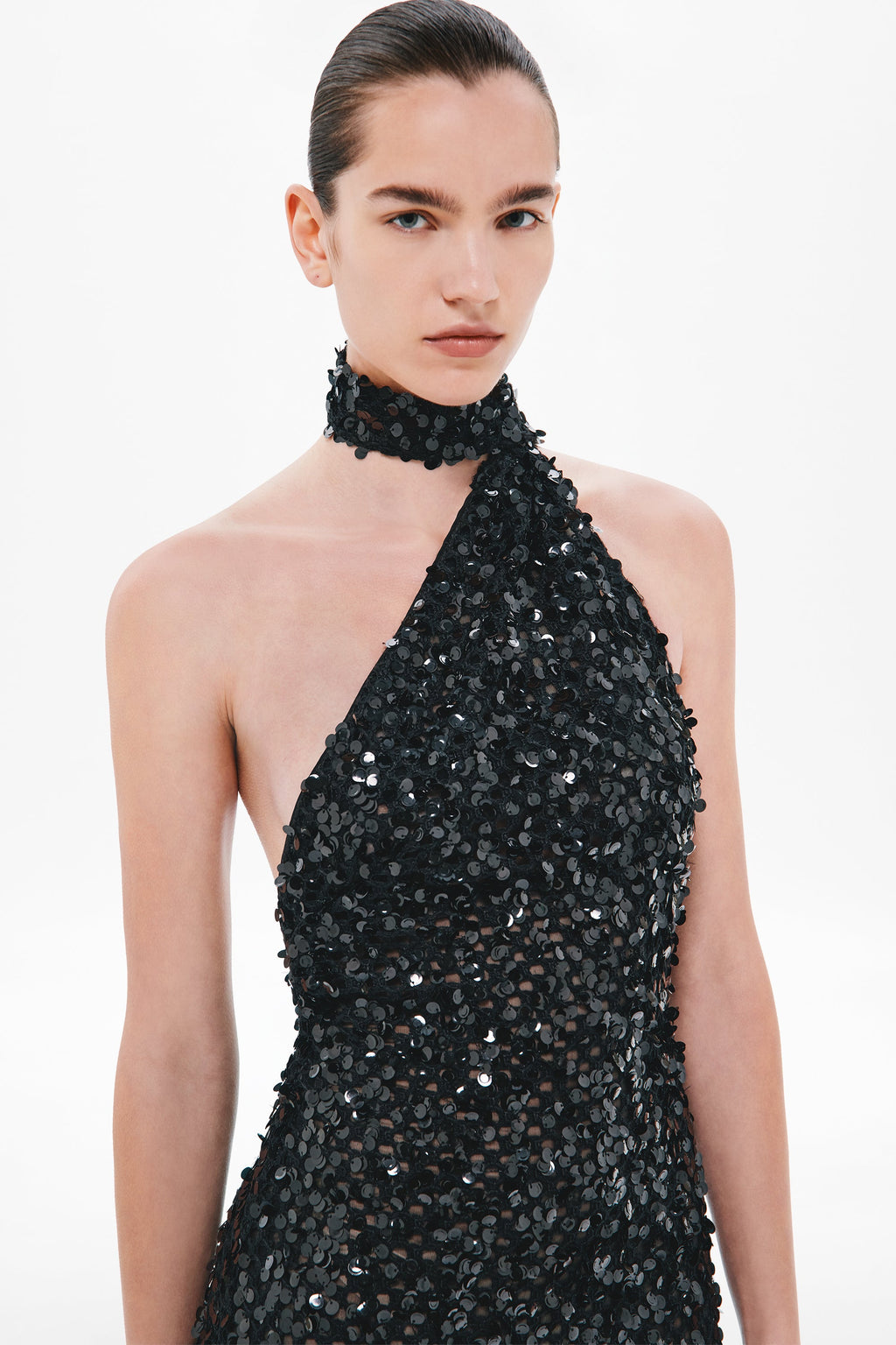 Black halter sequin crochet dress with choker neckline and sleeveless fitted bodice