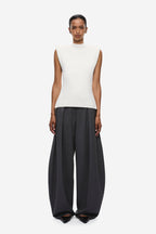 Ivory sleeveless knit top with high neckline