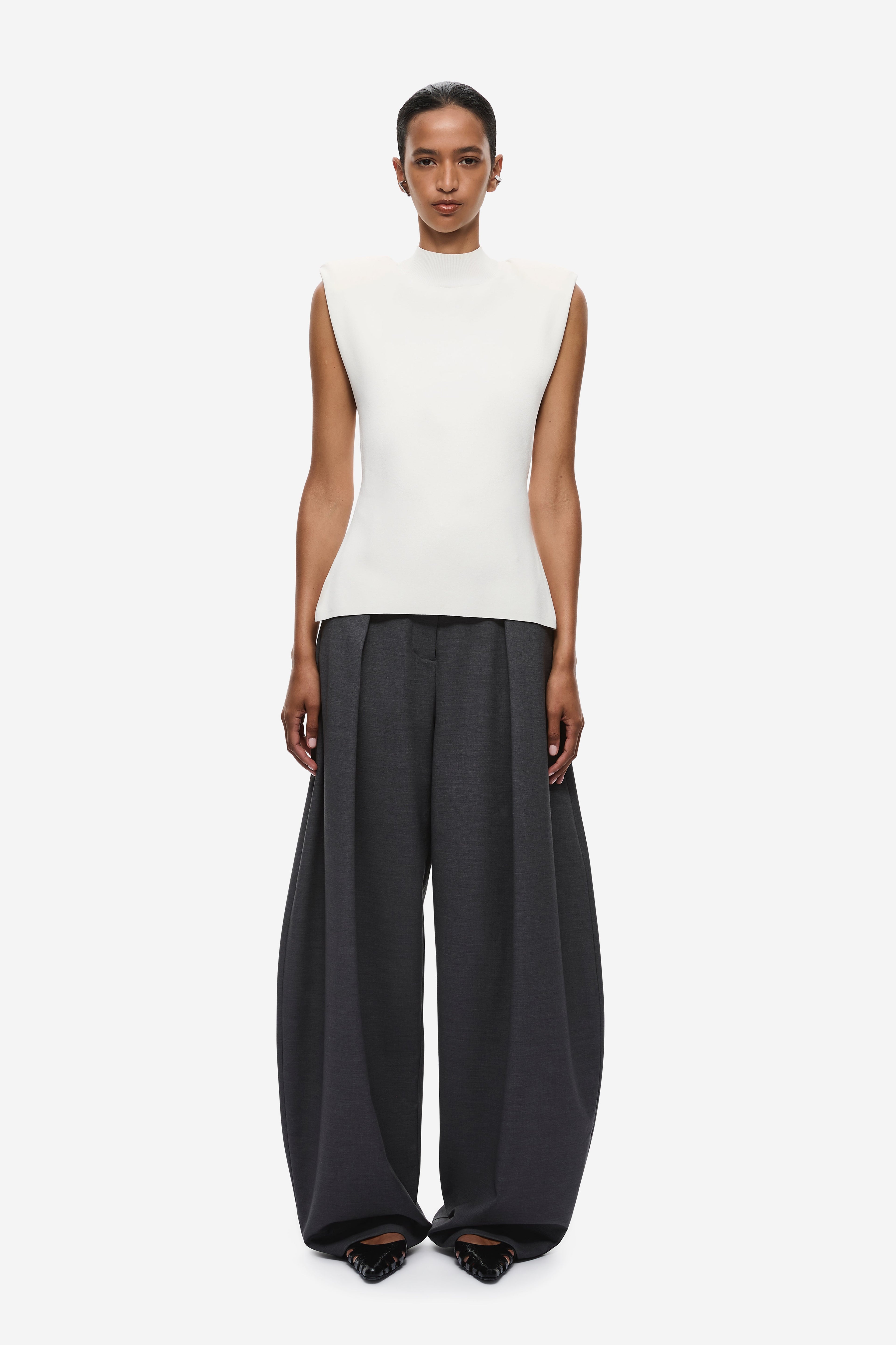 Ivory sleeveless knit top with high neckline