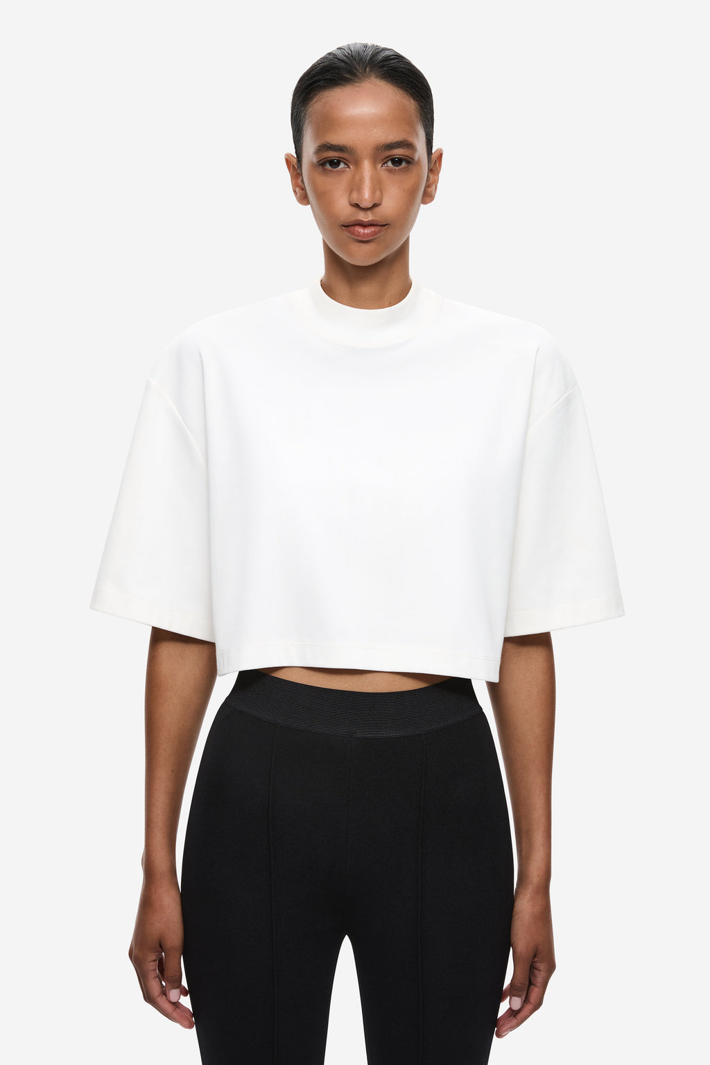 Front view of ivory oversized cropped T-shirt with crew neck and short sleeves