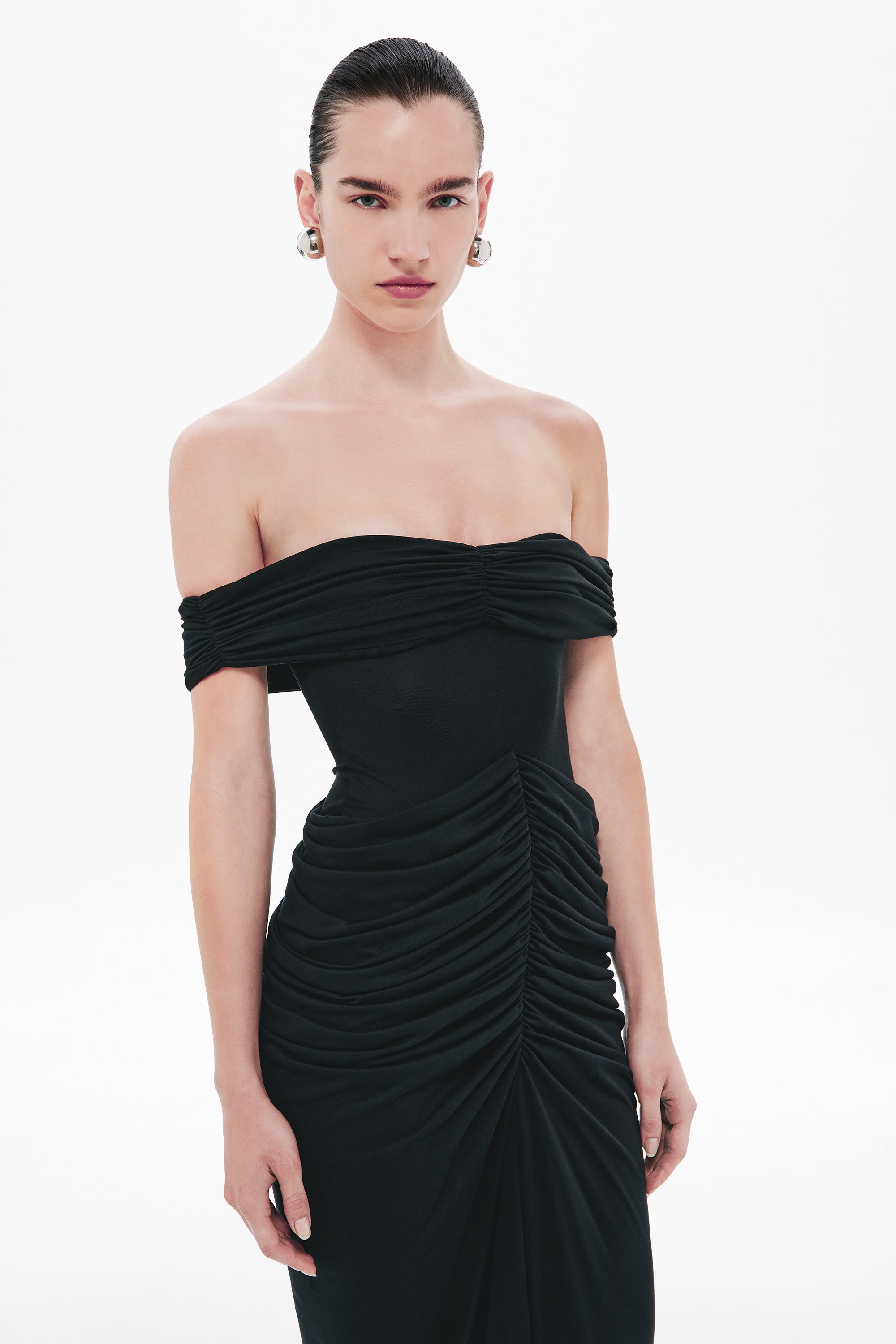 Black off-shoulder ruched maxi dress with draped paneling at the waist
