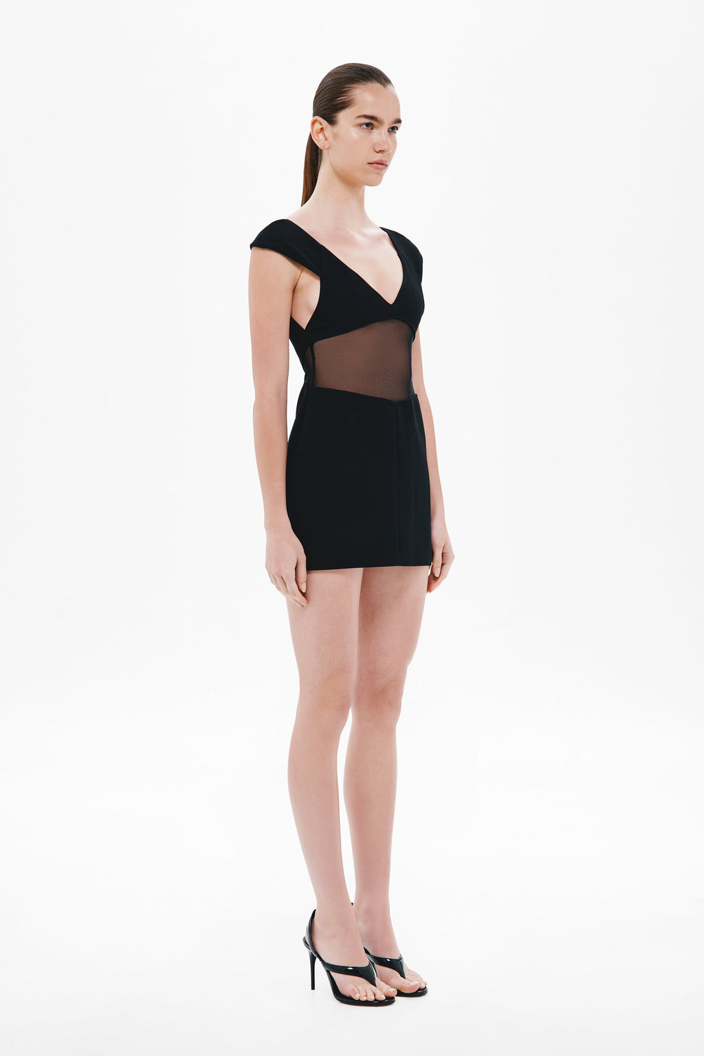 Black mini dress with V-neck and cap sleeves, sheer side panel details