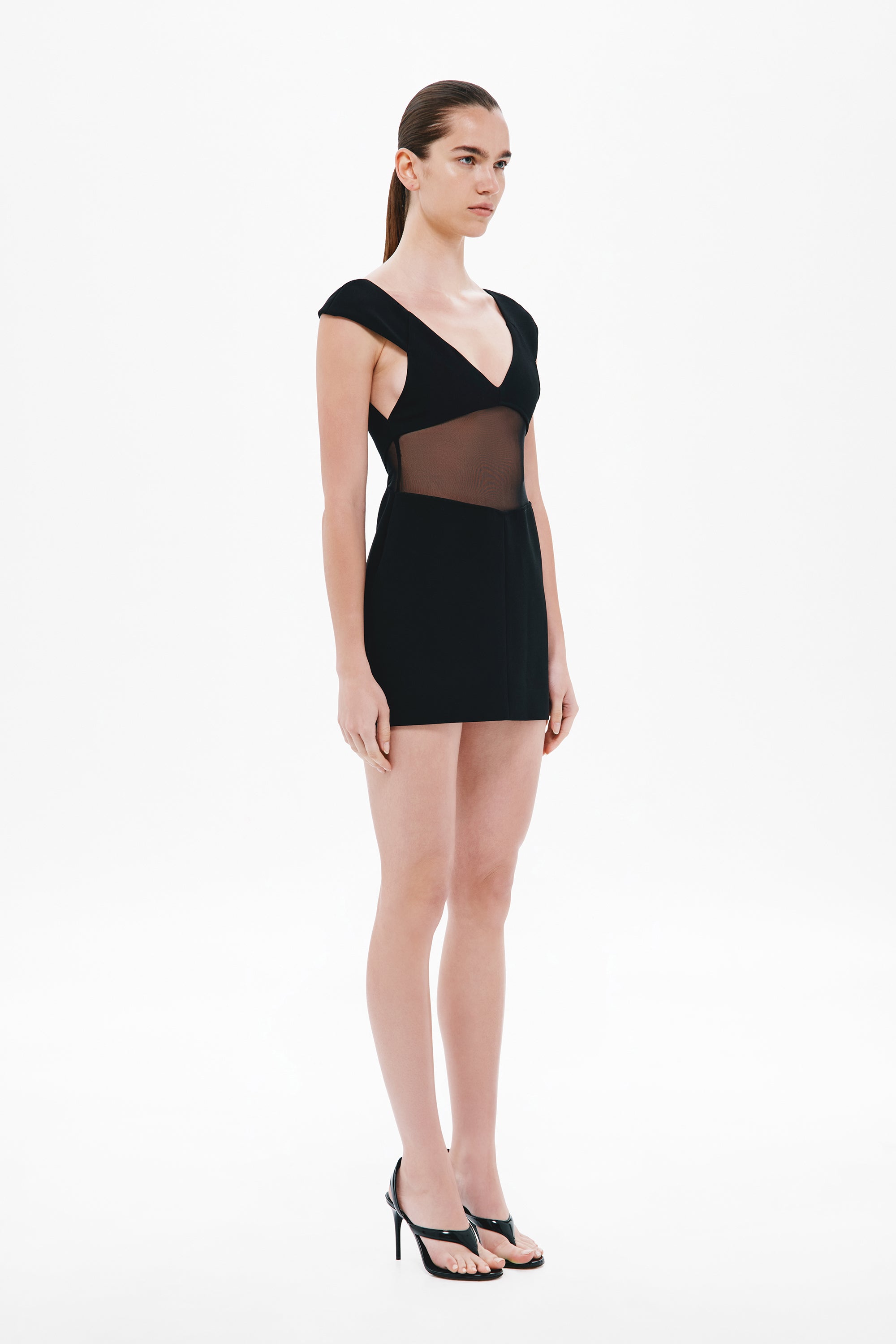 Black mini dress with V-neck and cap sleeves, sheer side panel details