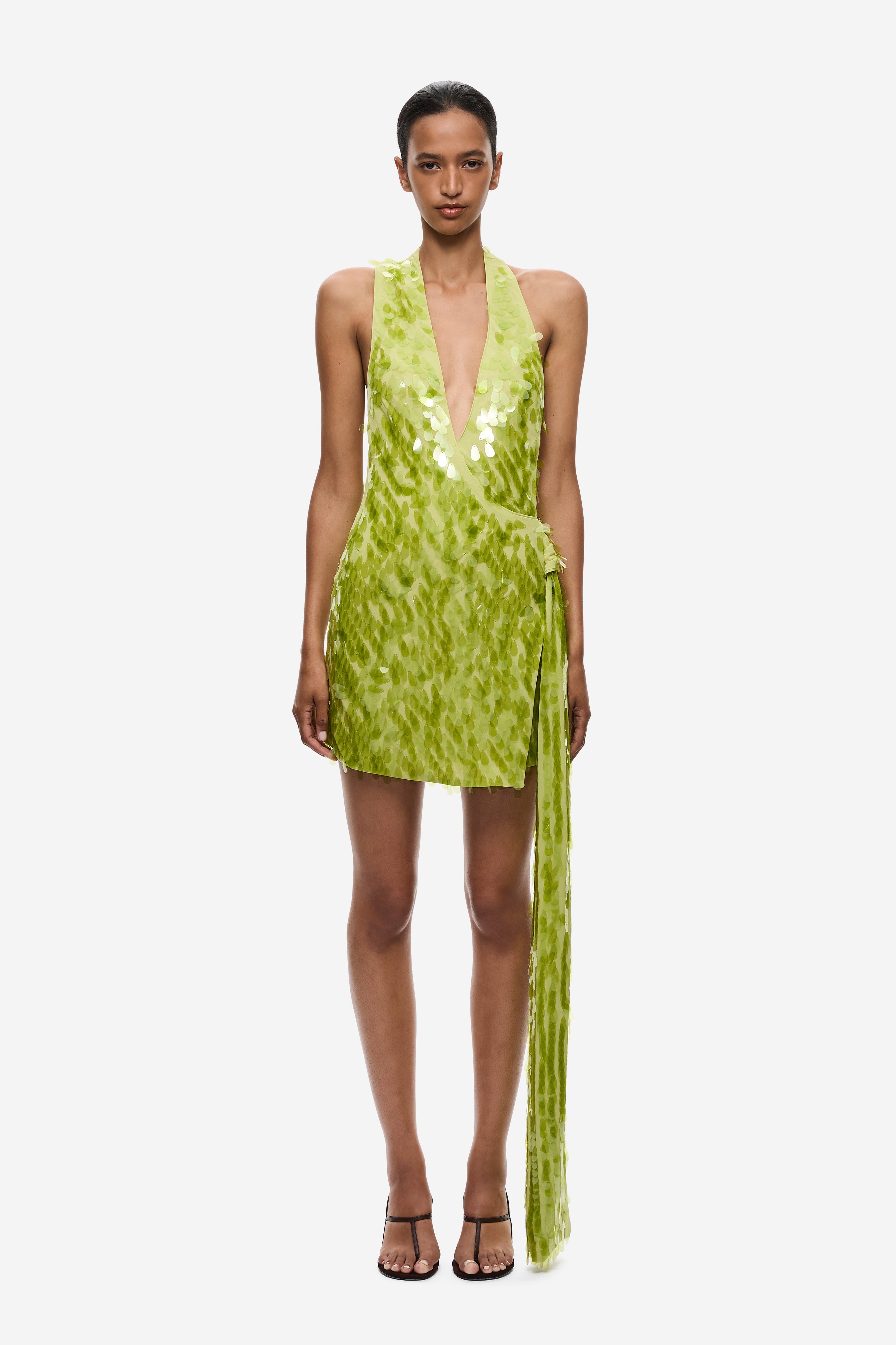 Lime green sequin mini dress with deep halter neckline and open back straps.