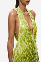 Lime green sequin mini dress close-up, deep halter V neckline with shimmering texture.