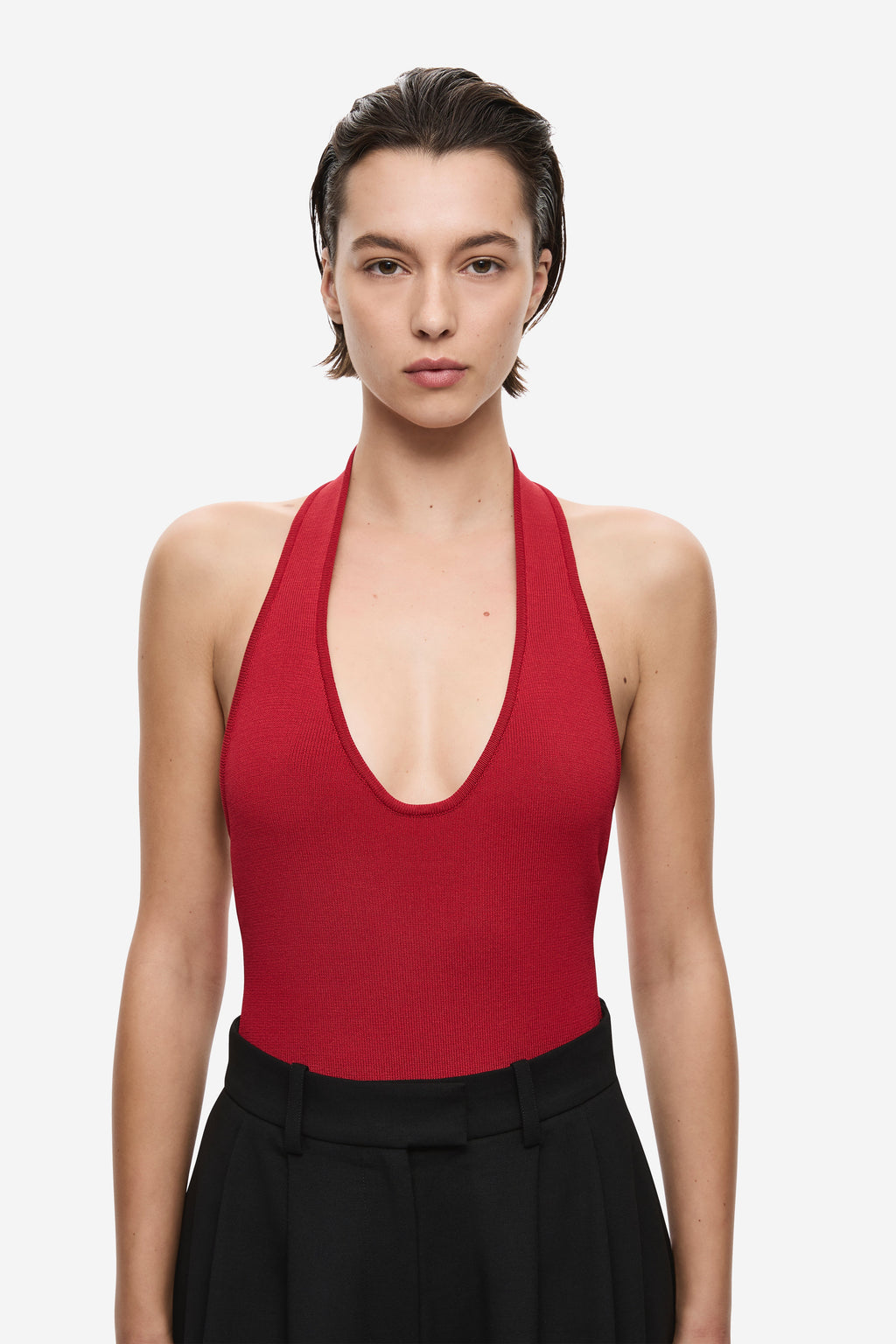 Cherry red knit bodysuit with halter scoop neckline, sleeveless fit