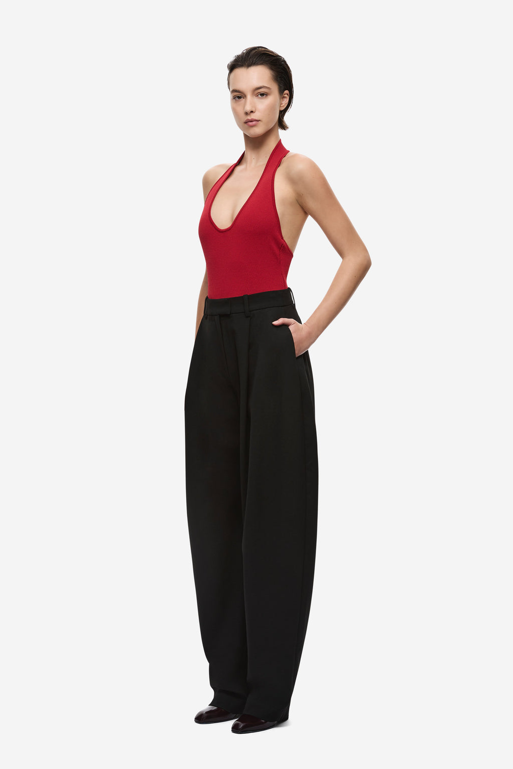 Cherry red knit bodysuit with halter strap and scoop neckline, fitted bodice