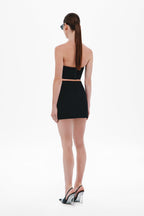 Black strapless draped bustier mini dress, back view with open back