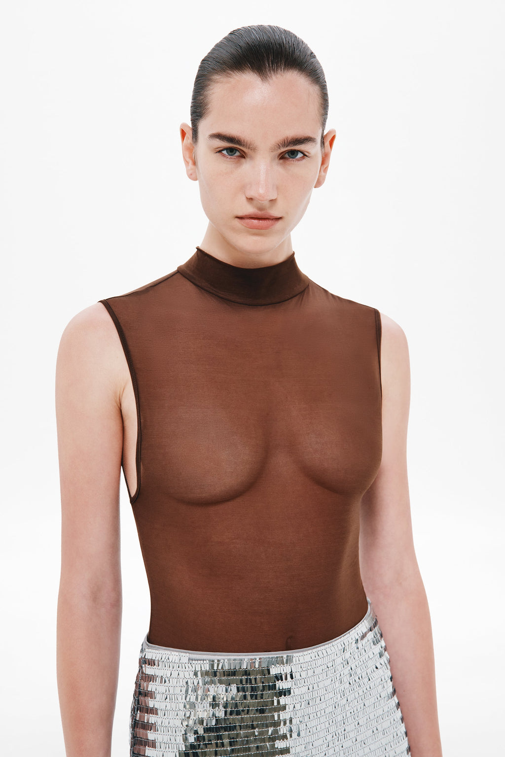 Chocolate brown sleeveless bodysuit with high mock neck, worn under a sequined skirt