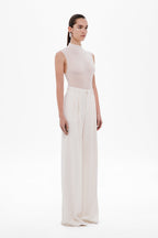Whisper white sleeveless mock-neck bodysuit, smooth fitted side profile