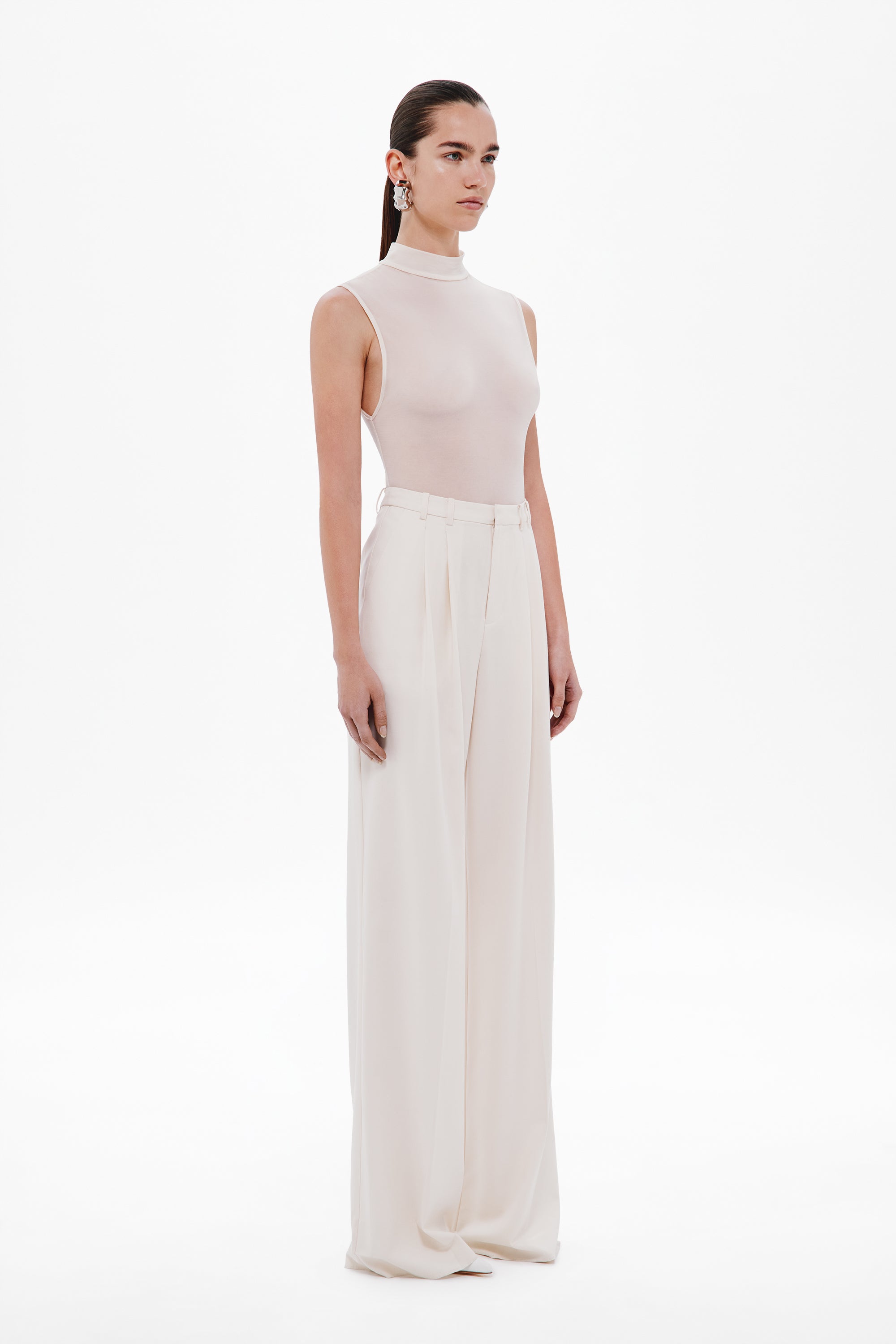 Whisper white sleeveless mock-neck bodysuit, smooth fitted side profile