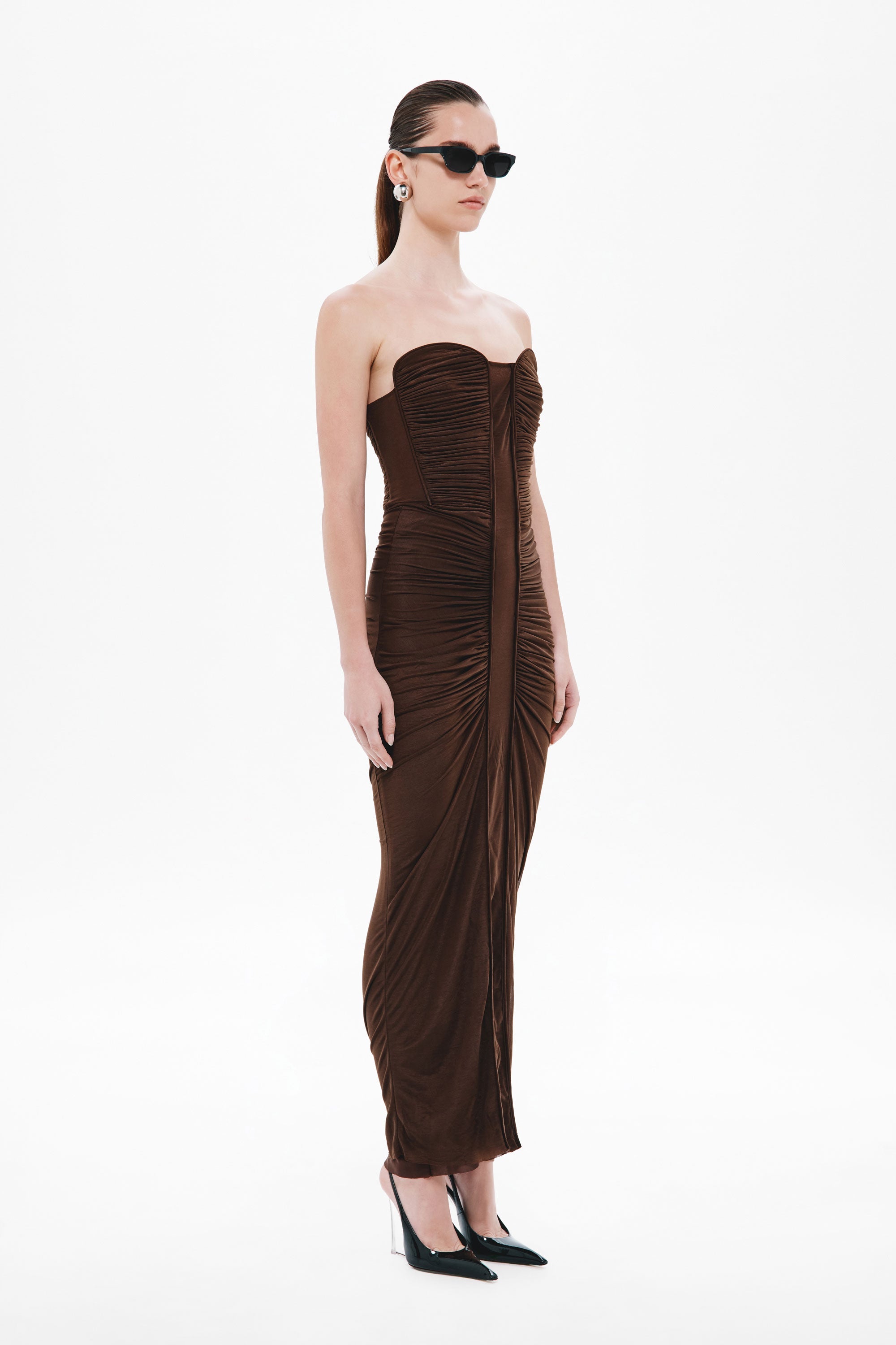 Dark brown strapless ruched midi dress with corset paneling and high slit at hem