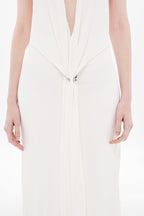 Ivory jersey dress chest close-up, draped V-front with small metal clasp