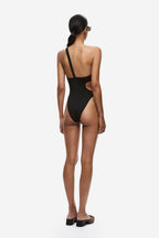 Back view of black one-piece swimsuit with thin straps and open back