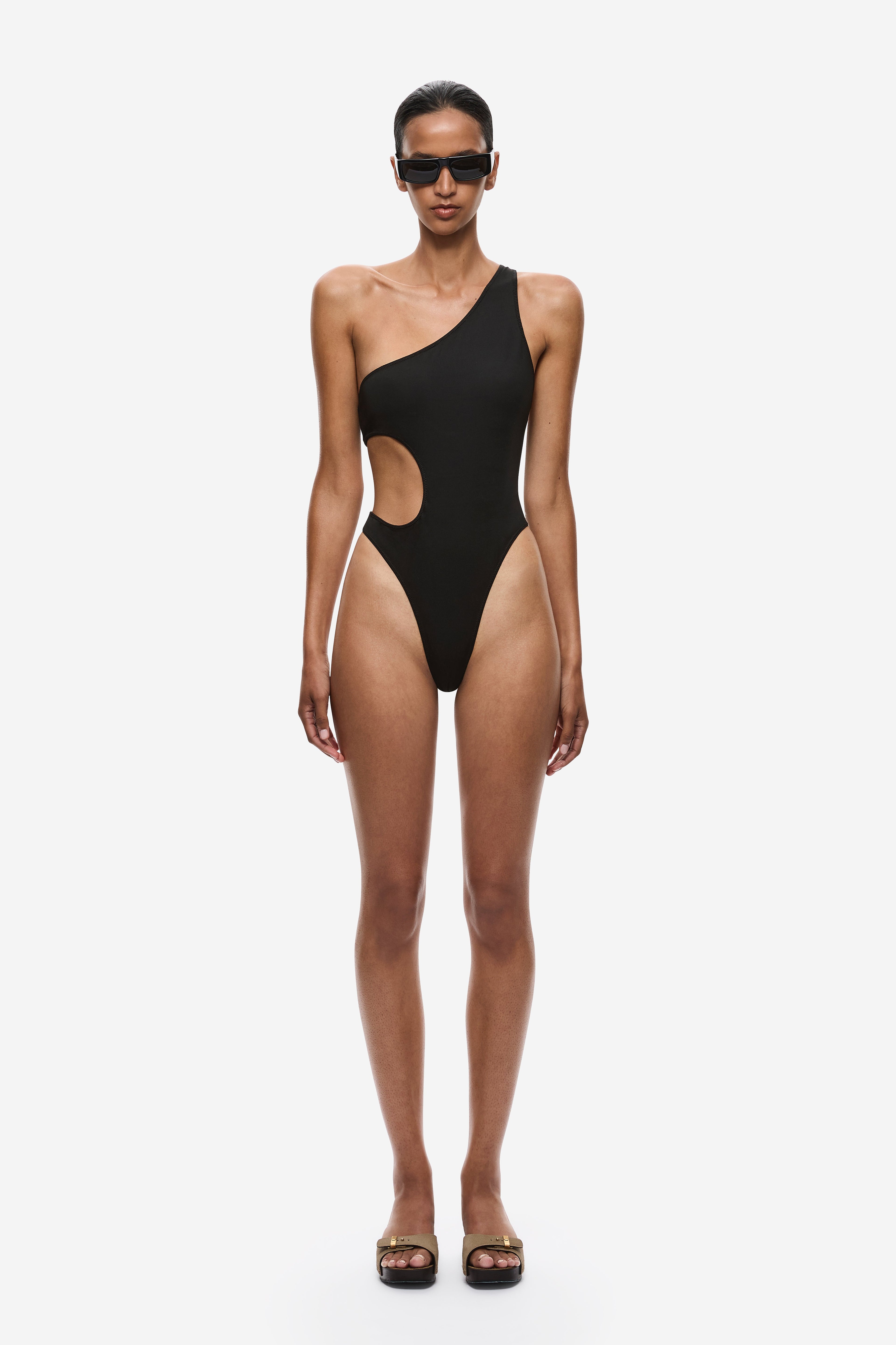 Black one-piece asymmetrical one-shoulder swimsuit with high-cut legs and hip cutout