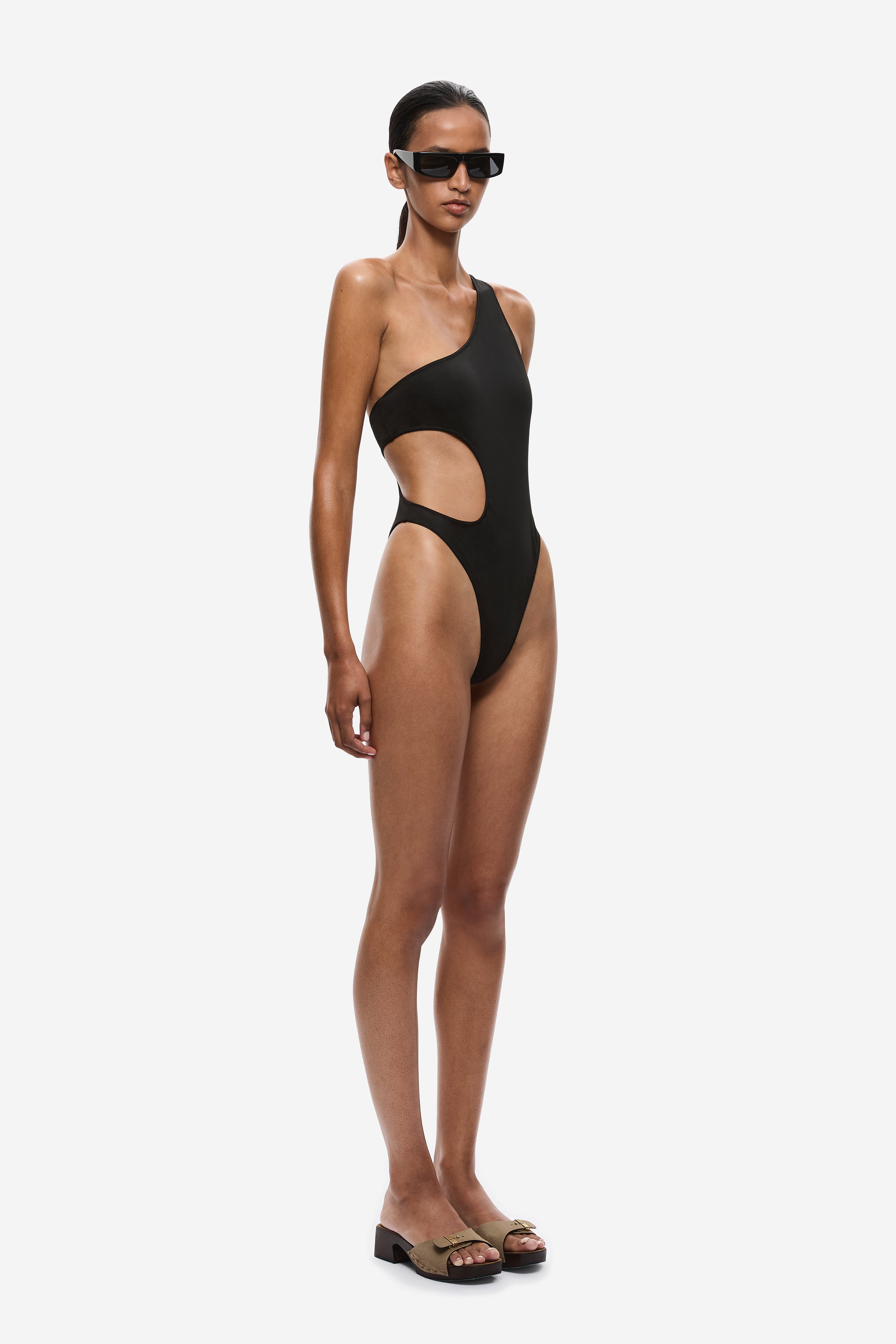 Black one-shoulder one-piece swimsuit with high-cut legs and side hip cutout