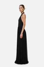 Black halter jersey maxi dress with V-neck and pleated skirt, sleeveless