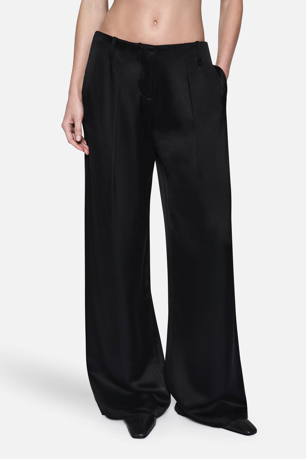 Black wide-leg acetate pants with high-rise waist, front pockets, and relaxed drape