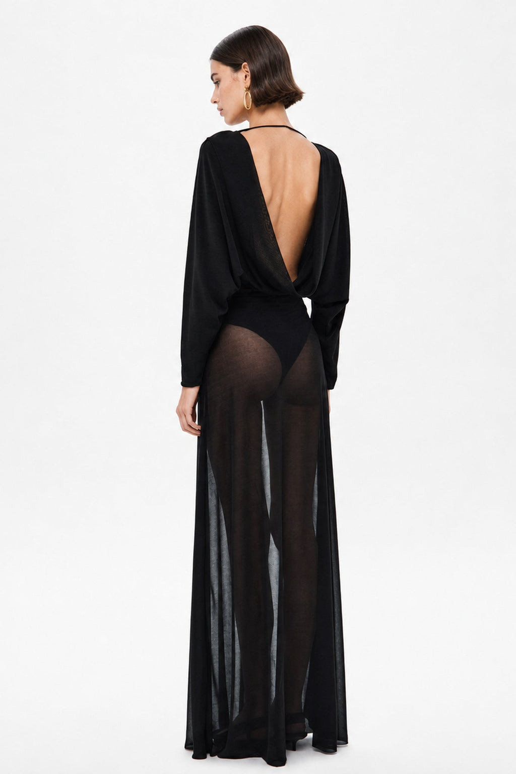 Black stocking-style dress with long sleeves, deep back cutout, sheer skirt panel