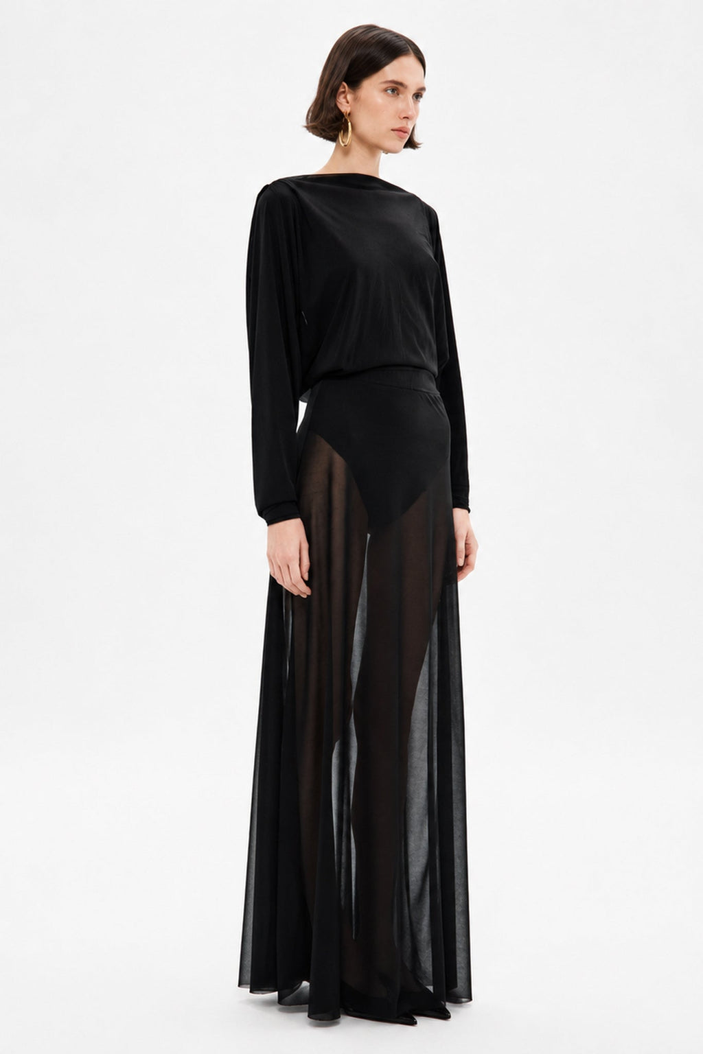 Black sheer maxi dress with long sleeves, draped top, and floor-length skirt