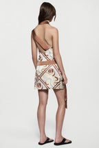 Printed silk mini dress with open back and swirling multicolor print