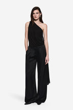 Black asymmetrical one-shoulder drape jersey bodysuit with flowing wide-leg bottom