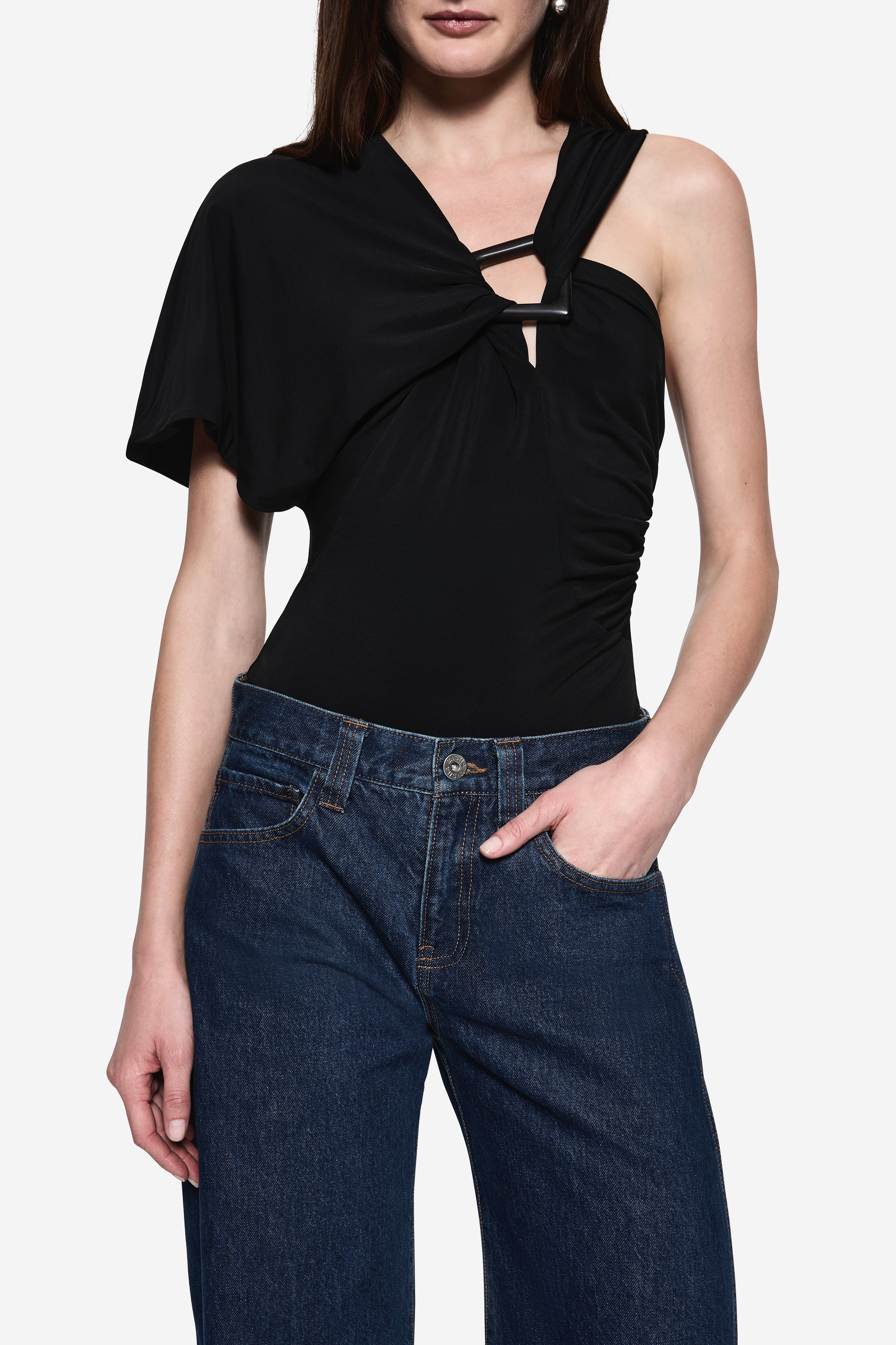 Black jersey bodysuit close-up: short sleeves, one-shoulder neckline, ring cutout