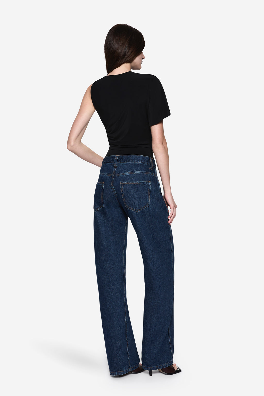 Black jersey bodysuit back view with short sleeves and draped one-shoulder style