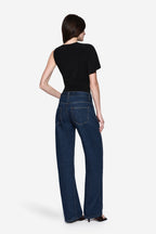 Black jersey bodysuit back view with short sleeves and draped one-shoulder style