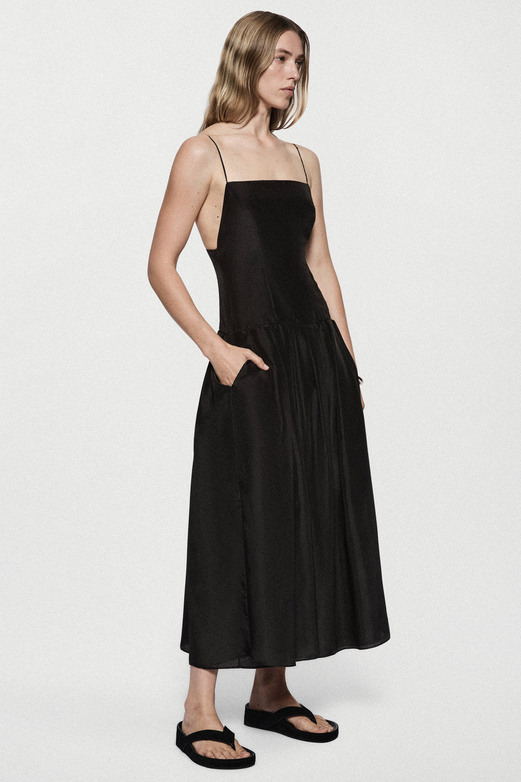 Black silk sundress side view with spaghetti straps and gathered midi skirt