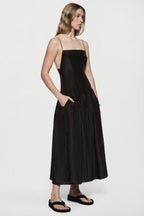Black silk sundress side view with spaghetti straps and gathered midi skirt