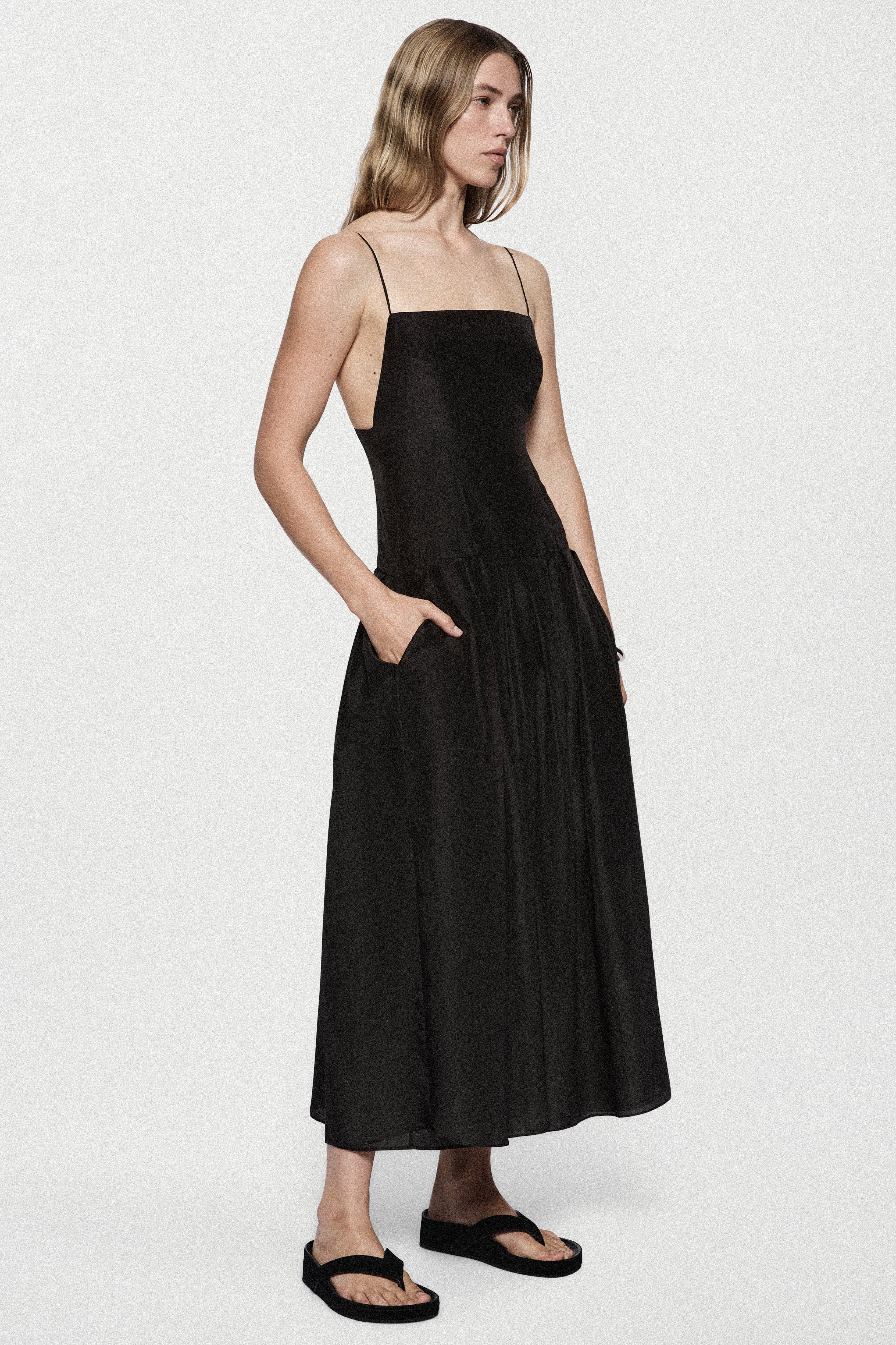 Black silk sundress side view with spaghetti straps and gathered midi skirt