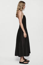 Black silk sundress profile view with spaghetti straps and full gathered skirt