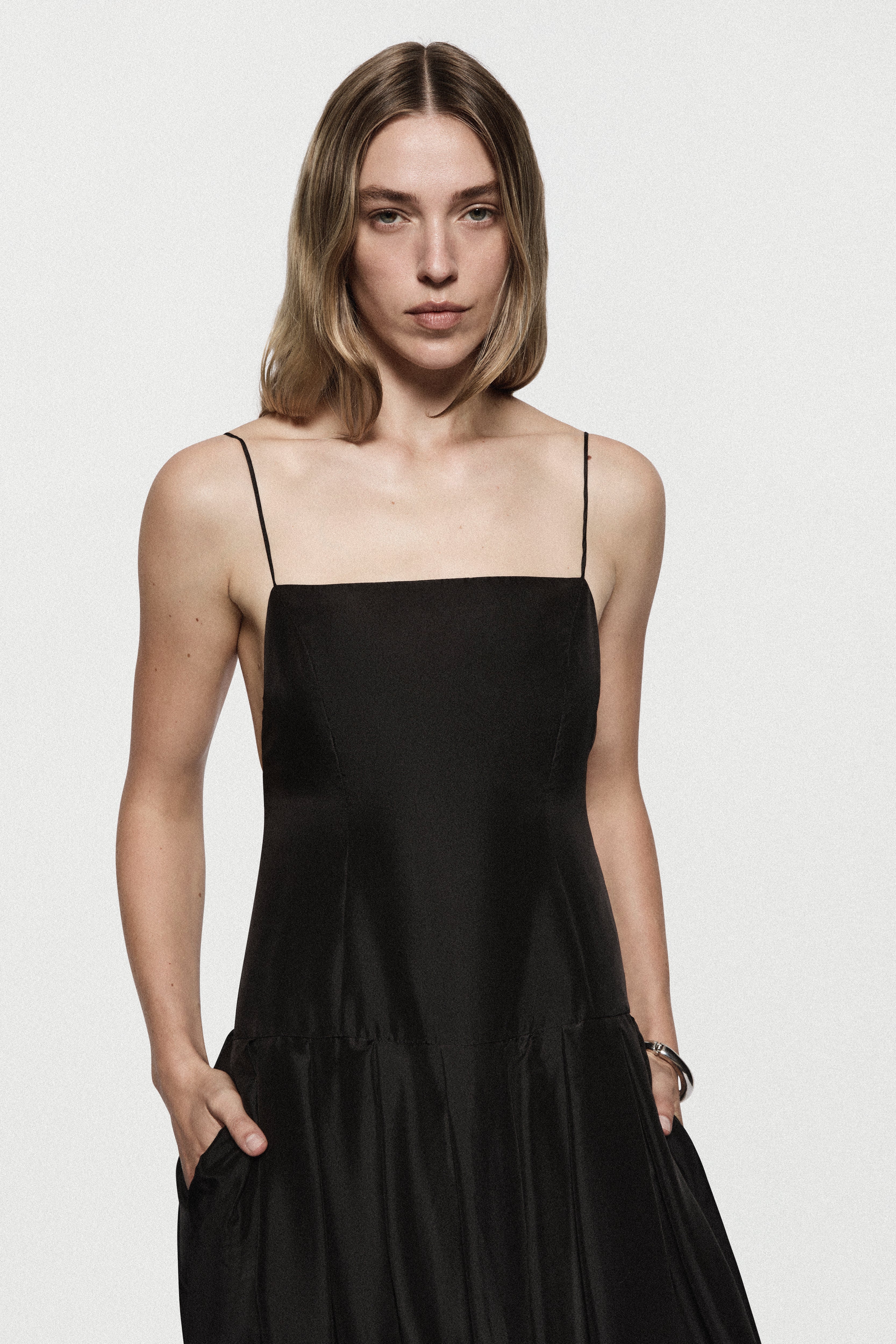 Black silk sundress front view with spaghetti straps and gathered skirt hem