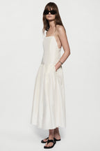 Women's silk sundress in winter white, spaghetti straps and tiered skirt, front view.