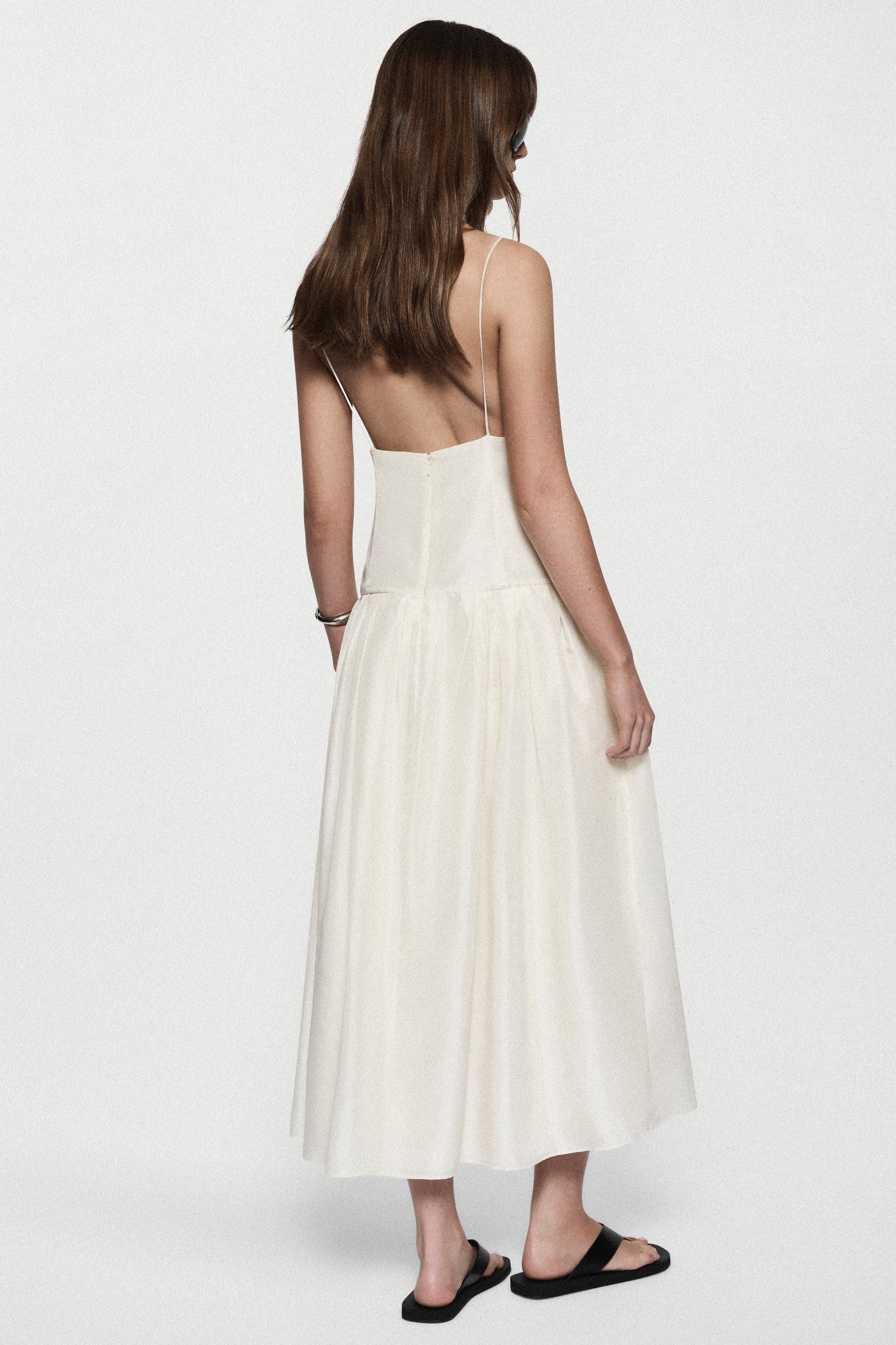 Women's silk sundress, winter white, spaghetti straps and tiered skirt, back view.