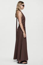Brown cotton halter maxi dress with fitted waist and draped side silhouette