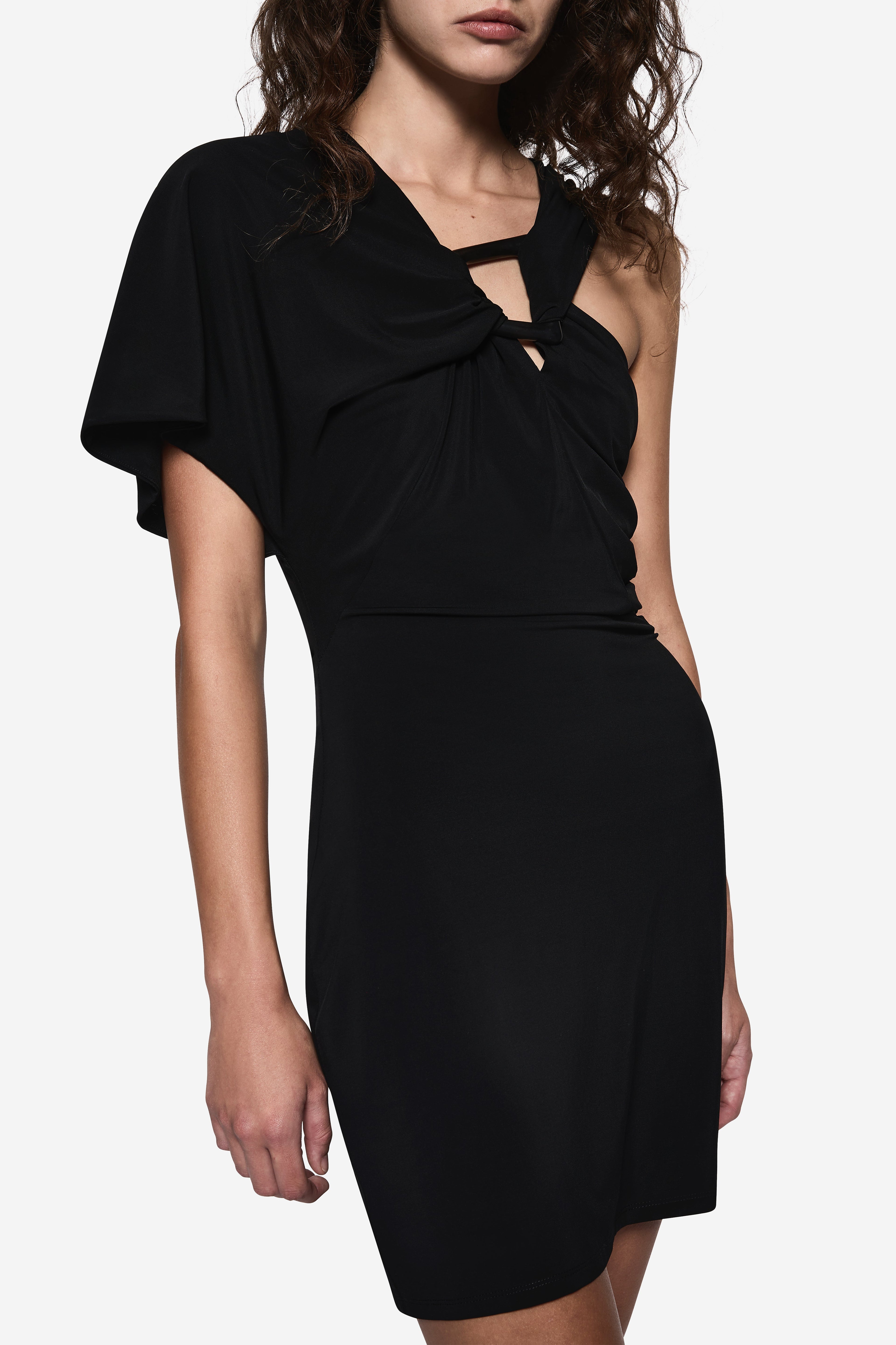 Black asymmetric mini dress close-up: draped knot neckline and side cutout