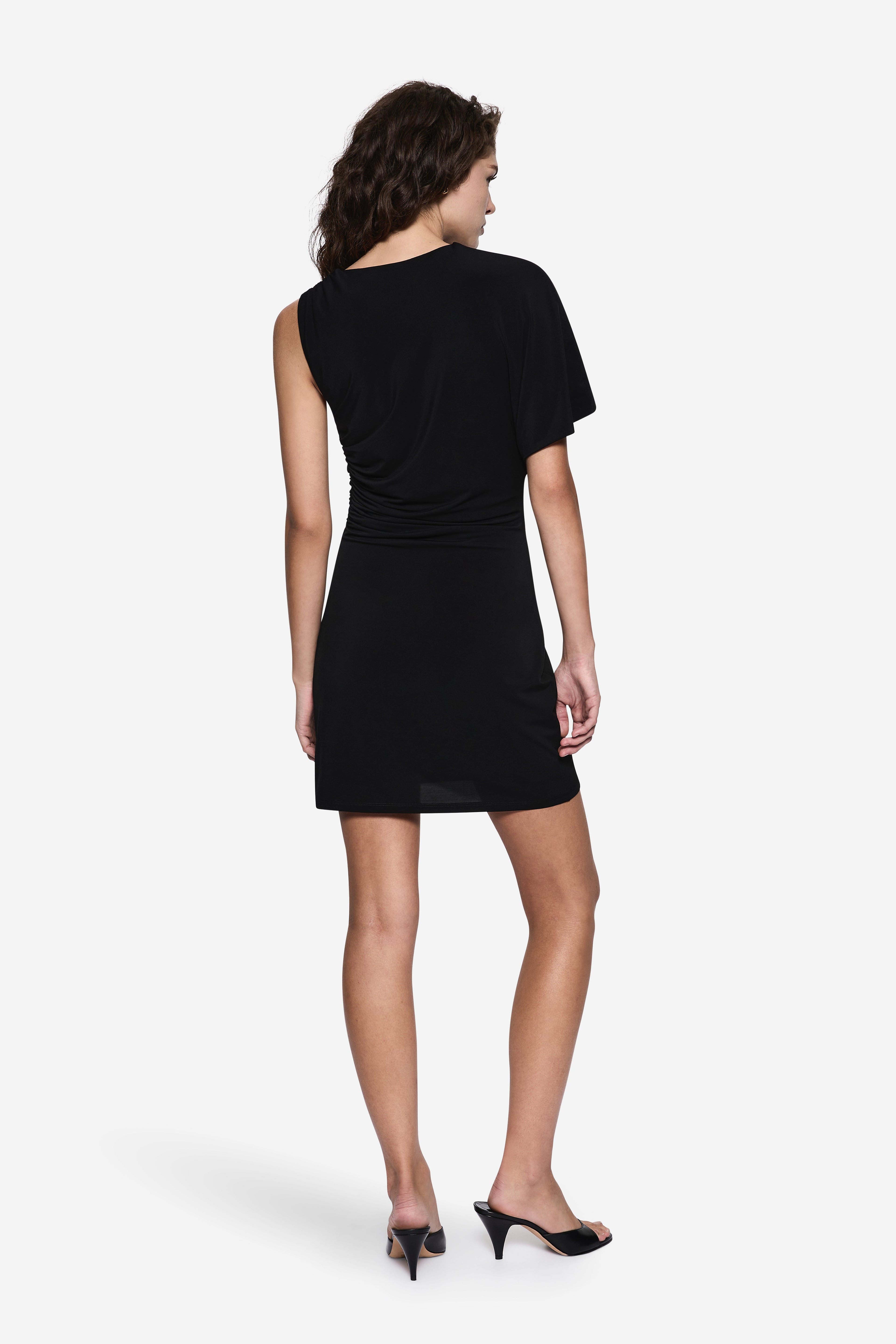 Back view of black asymmetric mini dress with short sleeves