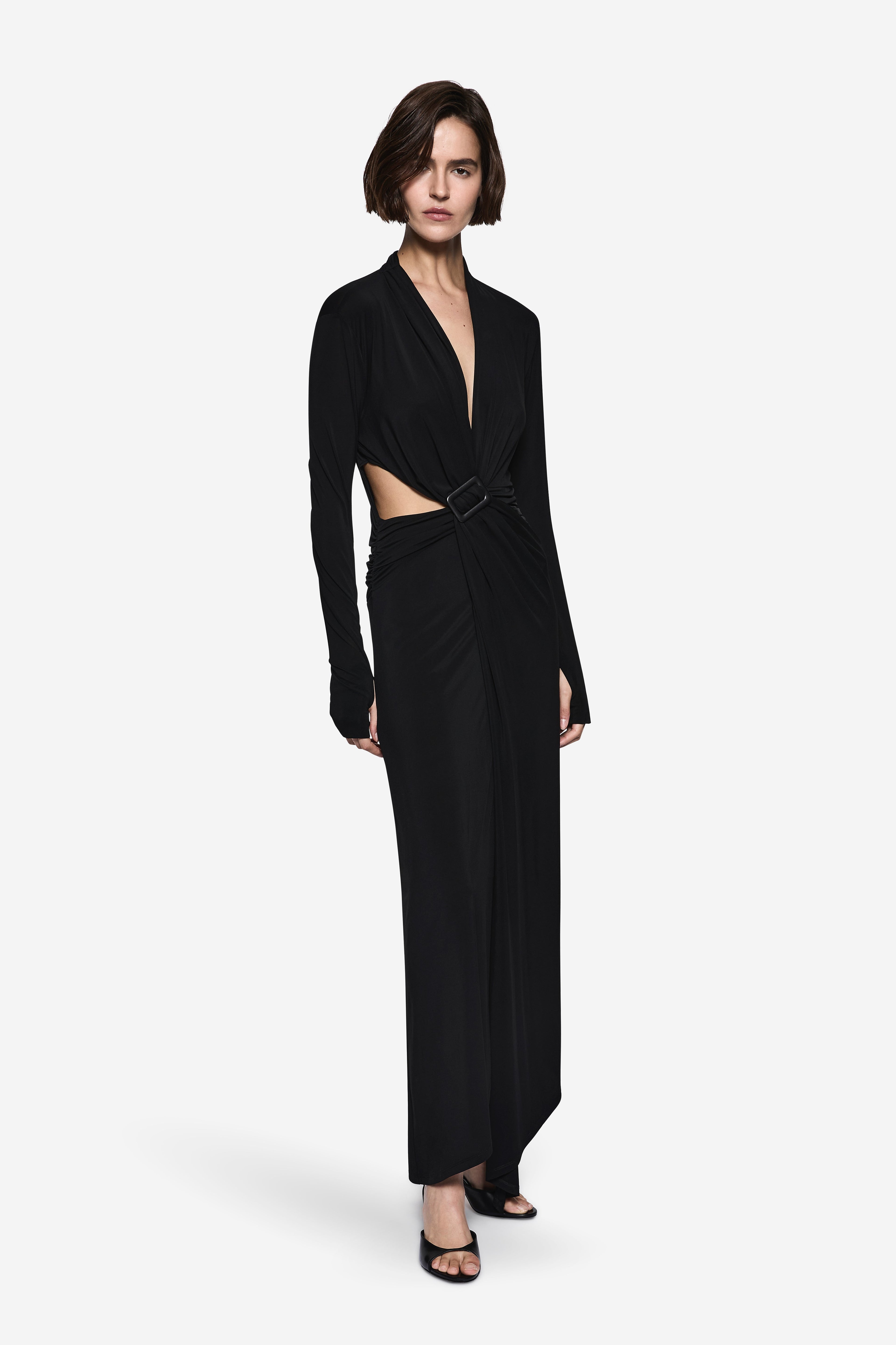 Black long-sleeve wrap dress with V-neck and waist belt, side view