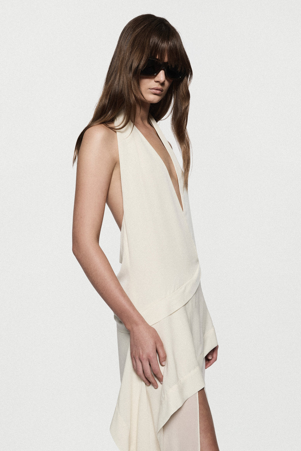 Off-white silk halter maxi dress with draped neckline and asymmetrical chest panel