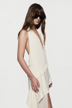 Off-white silk halter maxi dress with draped neckline and asymmetrical chest panel