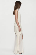 Off-white silk halter maxi dress with open-back drape and long flowing skirt