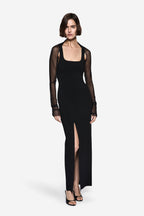 Black compact knit maxi dress with square neckline, side slit, sheer long sleeves