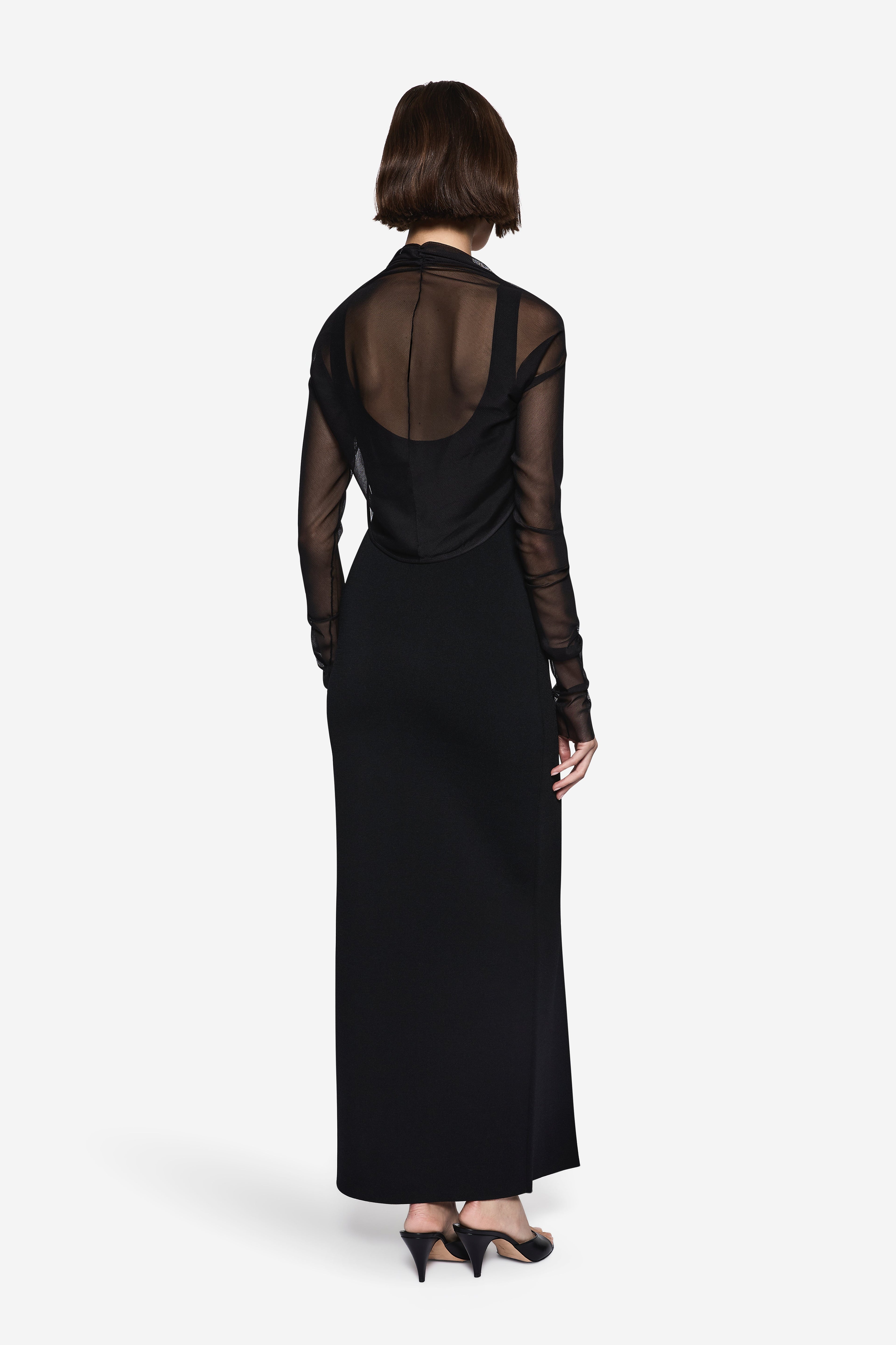 Black compact knit maxi dress with sheer long-sleeve back panel and floor-length hem