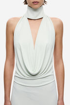 Light mint cowl-neck jersey dress close-up with halter collar and deep drape