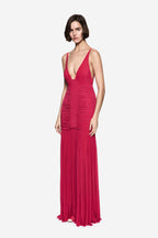 Hot pink sleeveless jersey maxi dress with deep V neckline and ruched bodice, fringe hem