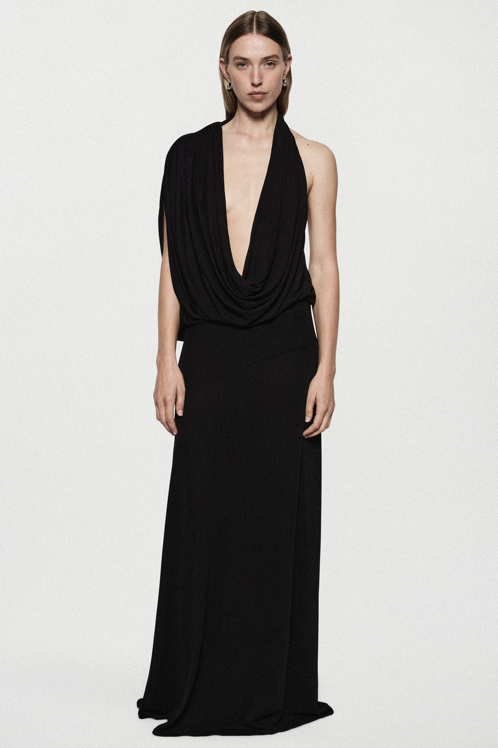 Black sleeveless jersey cowl gown with draped V neckline and long column skirt
