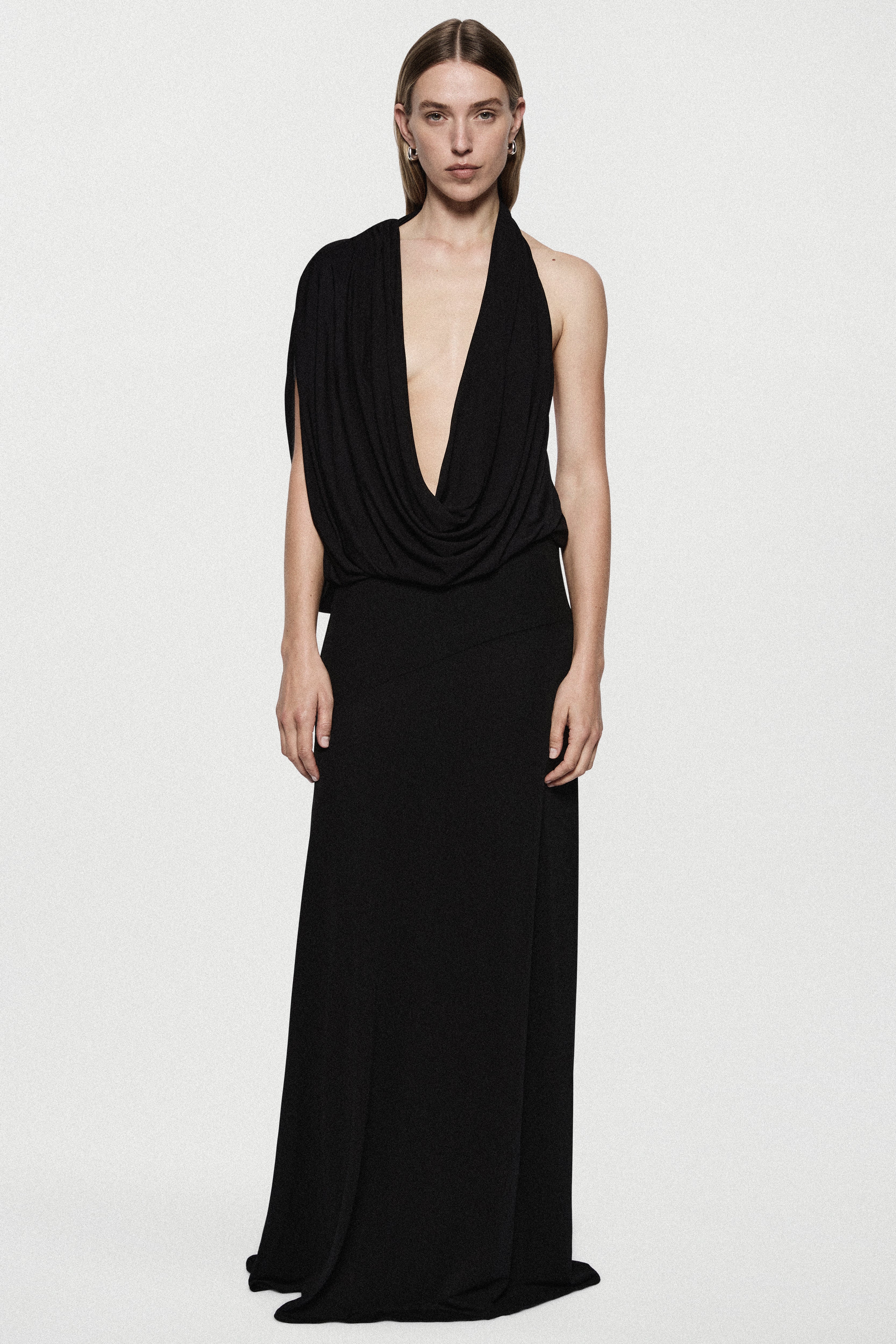 Black sleeveless jersey cowl gown with draped V neckline and long column skirt